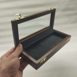 Elegant display case with glass lid for storing collectible knives or razors.